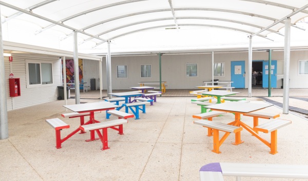 The benches in the covered outdoor area in the Youth Futures Community School in Midland