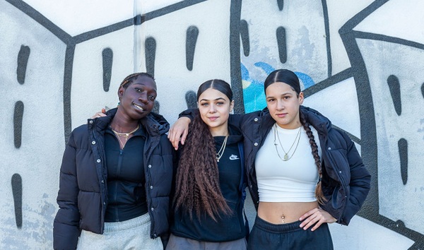 Three female students standing together at the Youth Futures Community School Midland
