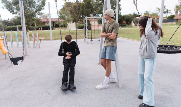 A few teens hanging out at a playground
