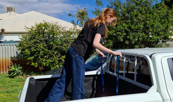 A woman packing a ute to move out