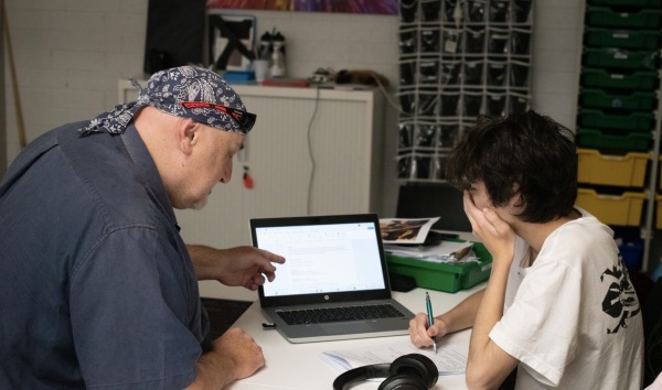 A Youth Futures teacher supports a young person with their learning.